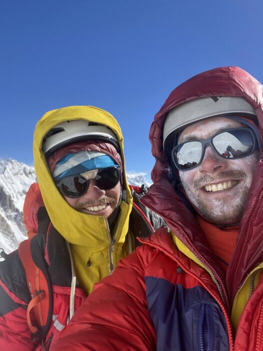 George Ponsonby and james Price on a summit in a sunny day. 