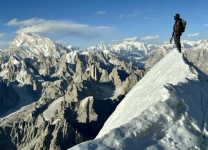 One of the three climbers on the summit of Chumik Kangri.