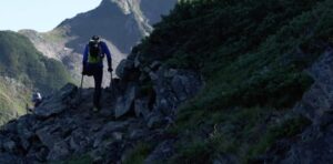silhouette of one-legged climber on mountain