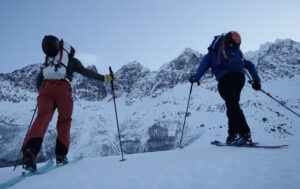 two skiers skiing into the picture