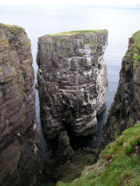 A tower of rock in the water.